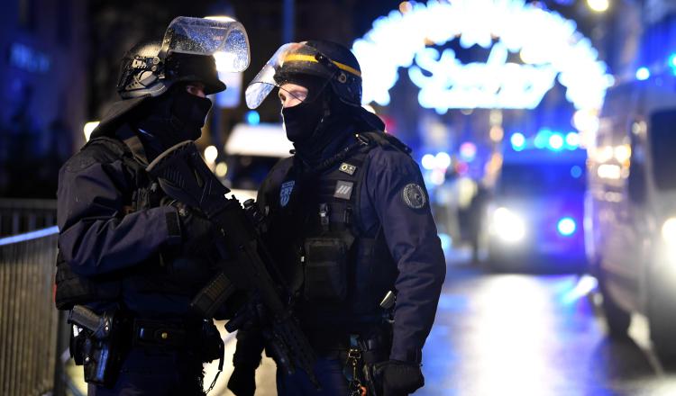 Oficiales de policía hacen guardia cerca a donde podría ubicarse al atacante tras un tiroteo mortal, en el Mercado de Navidad. EFE