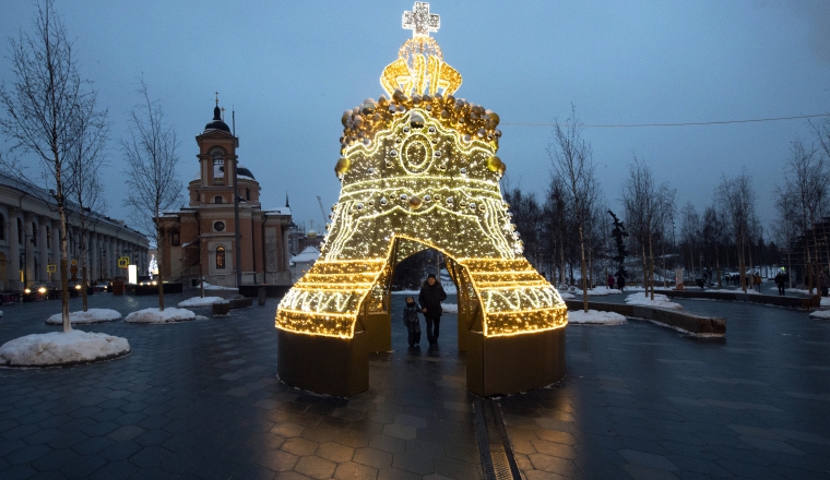 4.  Un hombre y su hijo pasan por un modelo luminoso del Tsar Bell en Zaryadye Park.