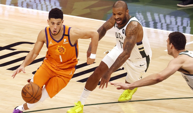 Devin Booker de los Suns (izq.) es marcado por P.J. Turcker. Foto:EFE