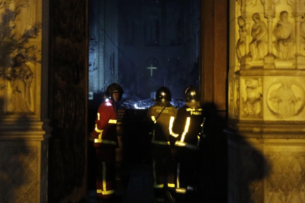 Bomberos franceses entran a Notre Dame mientras un incendio consume el techo de la catedral. FOTO/EFE