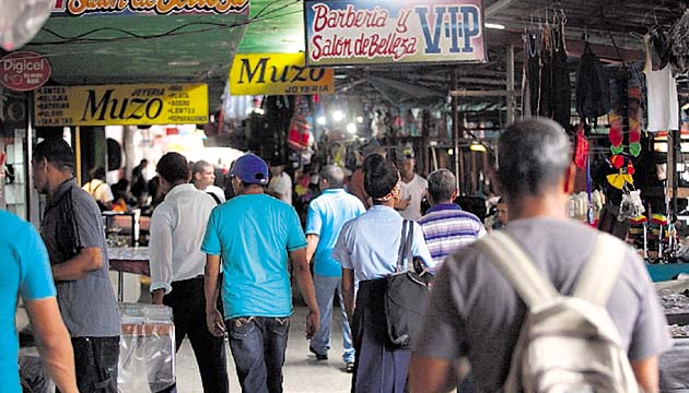Sin espacio para mirar. Las vitrinas comerciales que utilizaban los dueños de locales para atraer a los consumidores quedaron rezagadas por la buhonería que se tomó la vía para promover sus productos. Los peatones se quedaron sin espacio. (Edwin González)