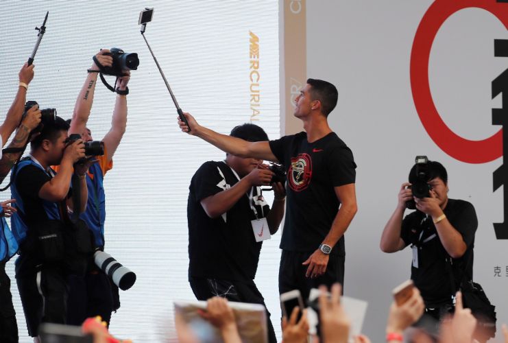 Cristiano Ronaldo (c) se hace un selfi durante un acto en Pekín. Foto EFE
