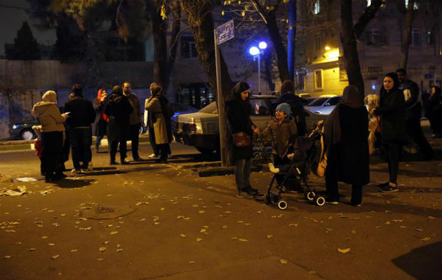 Iraníes esperan en una calle después del impacto de un terremoto. Foto: EFE