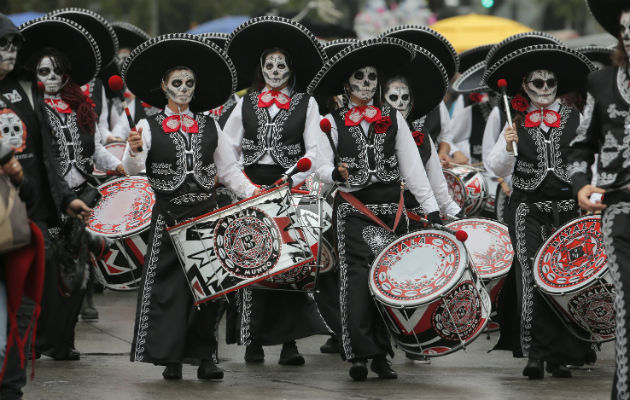 Indígenas comen sobre las tumbas en la celebración del Día de Muertos en Calpi, provincia de Chimborazo, Ecuador. Foto.EFE.