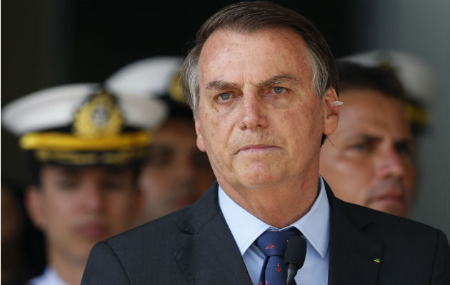 Pese a estar rodeado de escándalos, el presidente de Brasil, Jair Bolsonaro, ha logrado suprimir la disensión. Foto / Eraldo Peres/Associated Press.