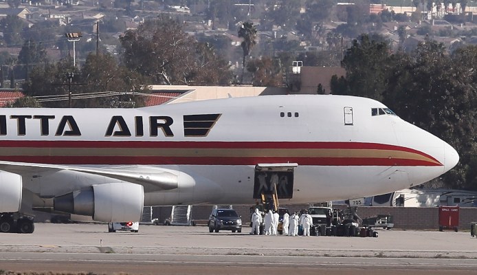 Las imágenes aéreas mostraron el avión proveniente de China estacionado en la mitad de la pista con la escalera extendida sin que los pasajeros descendieran inmediatamente. FOTO/AP