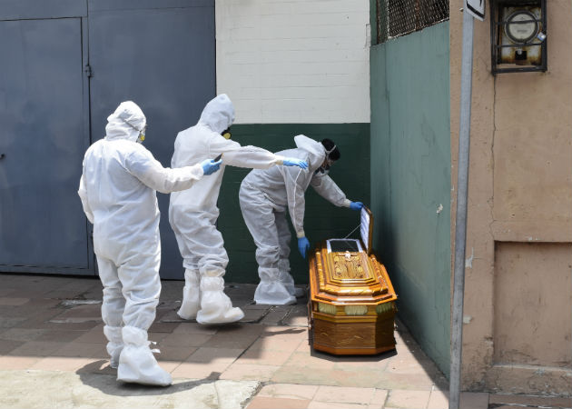 Vehículos cargan féretros en Guayaquil, con cuerpos de personas que se creen han muerto por coronavirus. Fotos: AP. 