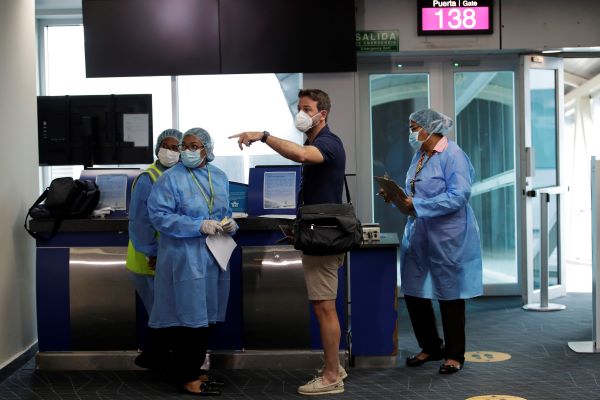 Thomas Christiansen es revisado por el personal médico del Ministerio de Salud (Minsa) a su llegada al Aeropuerto internacional de Tocume. Foto:EFE