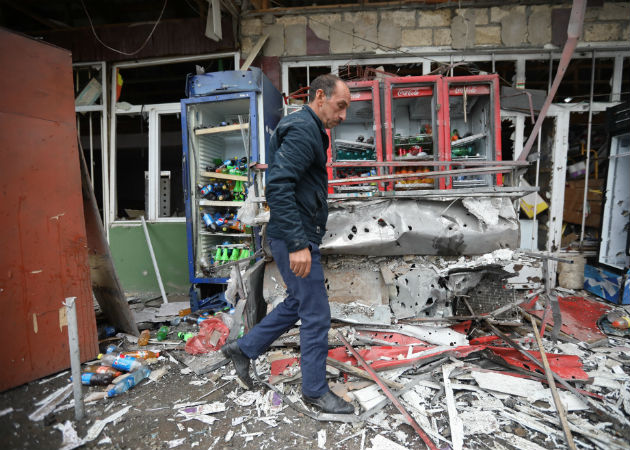 Una anciana armada cuida su casa en Stepanakert, la capital del enclave separatista de Nagorno Karabaj disputada por Azerbaiyán y Armenia. Foto: EFE. 