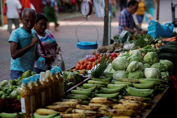 Clientes compran legumbres en puestos improvisados en una avenida peatonal de Ciudad de Panamá. Foto:EFE