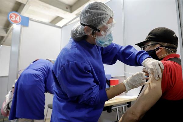 Un hombre recibe una vacuna contra la covid-10 en el centro de vacunación más grande en Colombia. EFE