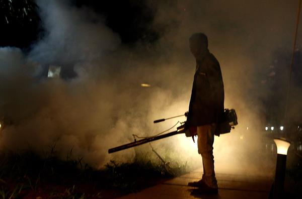 Un hindú fumiga las calles para erradicar al mosquito de la malaria en Cubbon Park. EFE