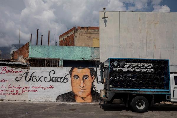 Un pequeño camión pasa junto a un grafiti con la imagen del rostro de Alex Saab en Caracas (Venezuela), en una imagen de archivo. Foto: EFE