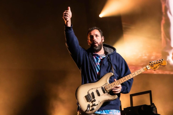 Adam Sandler receives an award for his career as a comedian