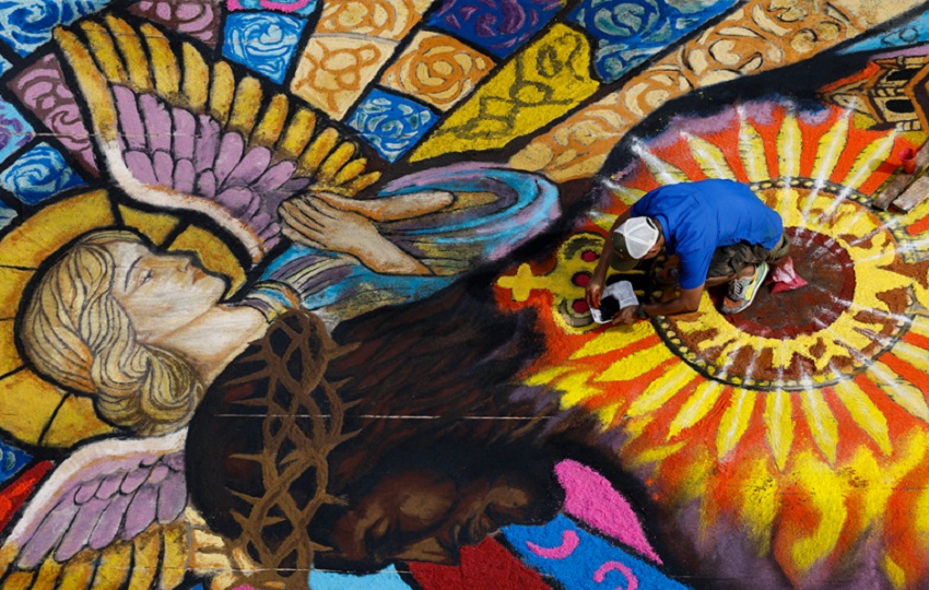 Un hombre realiza una alfombra de serrín en la Fiesta del Corpus Christi en la Villa de Los Santos (Panamá). EFE