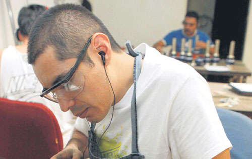 <p>Oportunidad. Un artesano trabaja en un taller de Guadalajara (México) sobre un decorado que será usado en la misa.</p>
