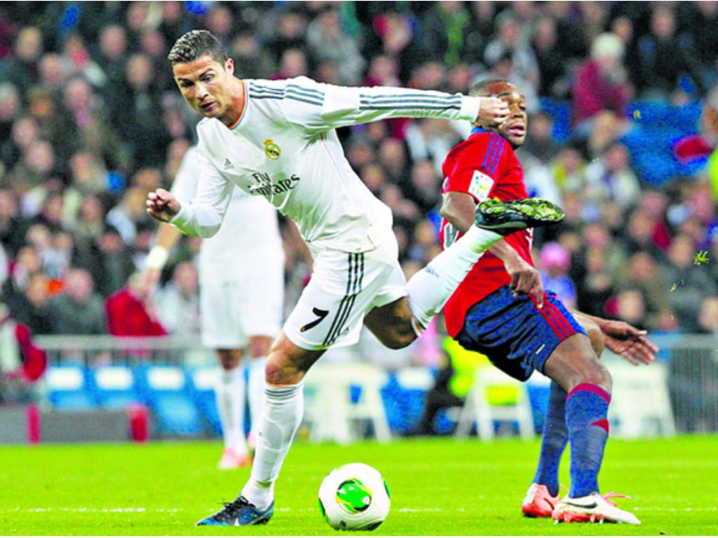 Cristiano Ronaldo (izq.) lucha un balón con el francés Raoul Loe durante el partido de ida de los octavos de final de la Copa del Rey.(EFE)