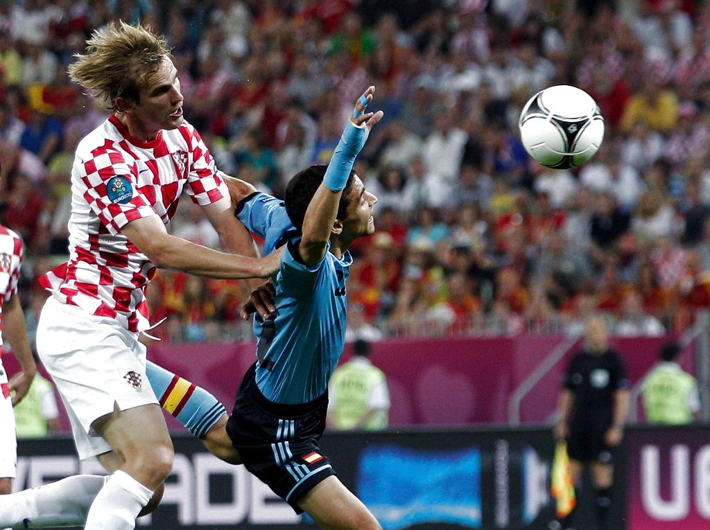 El jugador croata Ivan Strinic (i) disputa un balón con Jesús Navas. Foto: EFE<br>