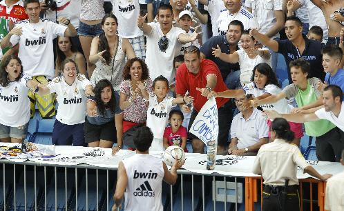 Un jugador del Real Madrid regala una pelota a los aficionados. Foto/EFE<br>