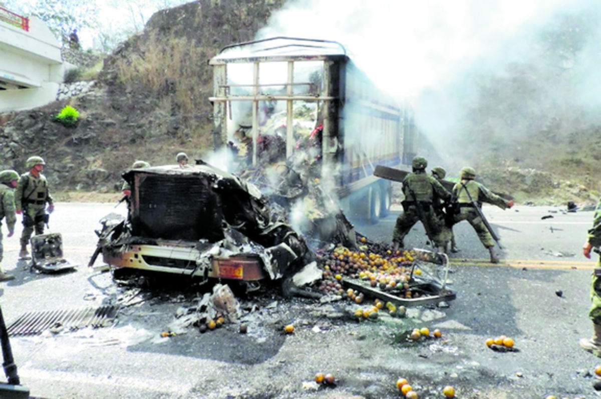 Miembros del Ejército mexicano sofocan el incendio de un camión.(EFE)