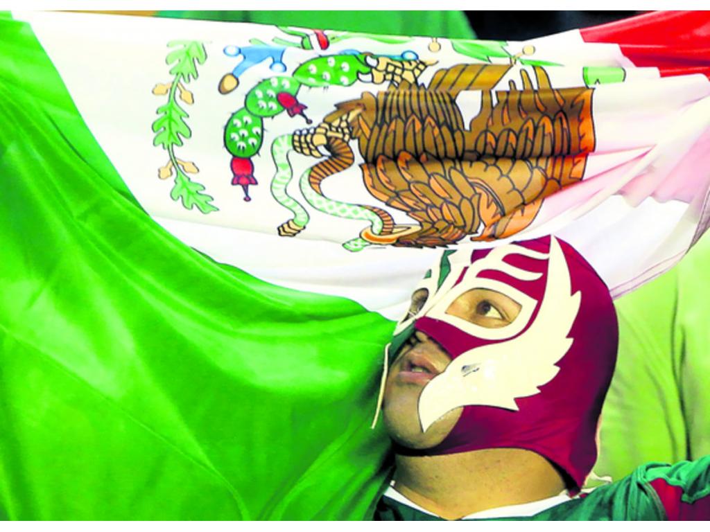 Un aficionado de la selección de México agita una bandera mexicana, antes del inicio del partido ante Panamá. Los mexicanos también le pusieron sabor al duelo de anoche.(Foto:EFE )