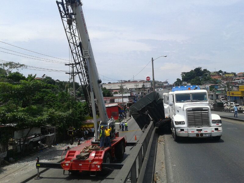 Grúa levanta contenedor recostado sobre el barandal del puente. Foto/Abel Rodríguez<br>