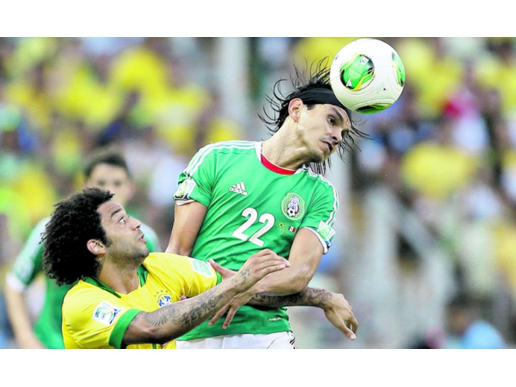 Marcelo (izq.) disputa el balón con el jugador mexicano Gerardo Flores (22).(AP)