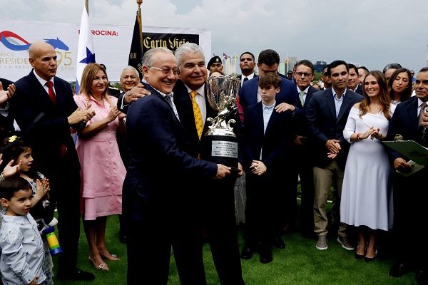El presidente Mulino (der.) entrega a Eric Antonio Del Valle la copa del ganador. Foto: Víctor Arosemena.