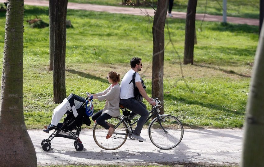 Una pareja pasea en bicicleta con el carrito de bebe a remolque.  Foto: EFE / Kai Försterling