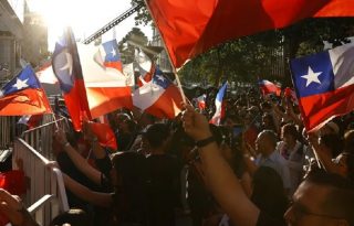 Simpatizantes de la candidata a la Presidencia de Chile por el partido Unidad por Chile, Jeannette Jara, sostienen banderas, en Santiago (Chile). Foto: EFE/ Elvis Gonzalez