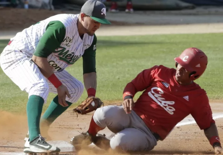 Jorge Aloma, de Cuba, llega a salvo a la tercera base que cubre el mexicano Agustín Murillo. AP