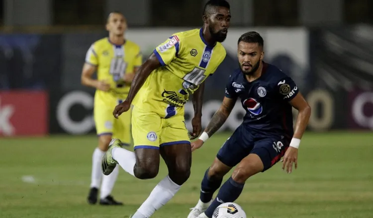 Everardo Rose  de Universitario (izq.) disputa un balón contra Omar Elvir de Motagua. Foto:EFE
